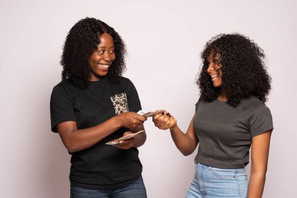 Two colleagues exchanging cash